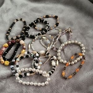 Bundle Of 16 Beaded Bracelets in Black, Silver Tone, Browns, And Blue And Grey